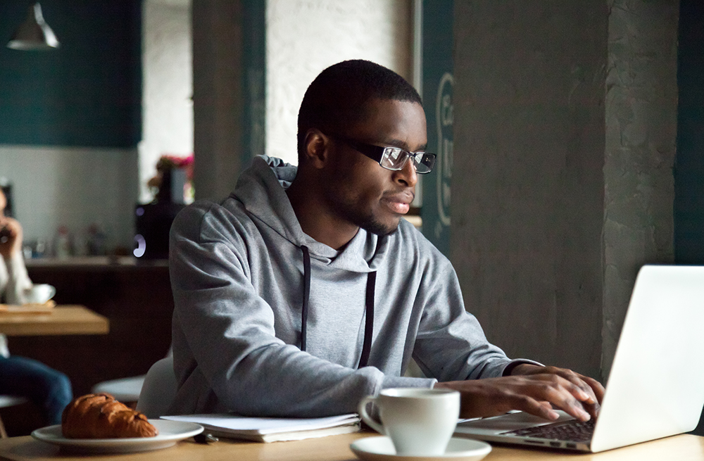 Man typing on a computer searching for Eversense diabetes resources.